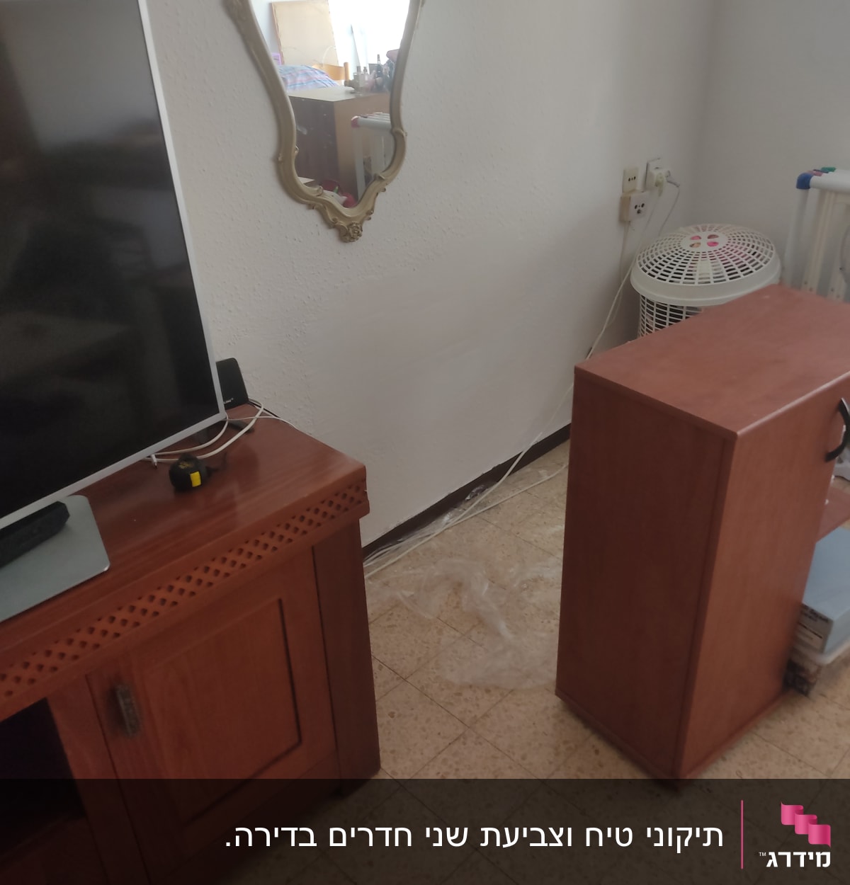 מראה עם מסגרת מוזהבת תלויה על קיר לבן